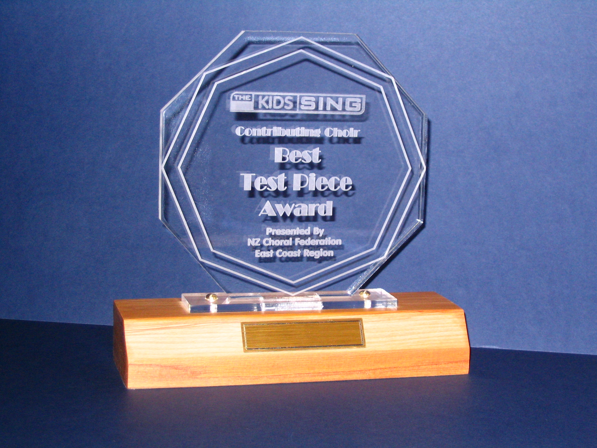 Example of trophy and engraving with wooden base and acrylic topper